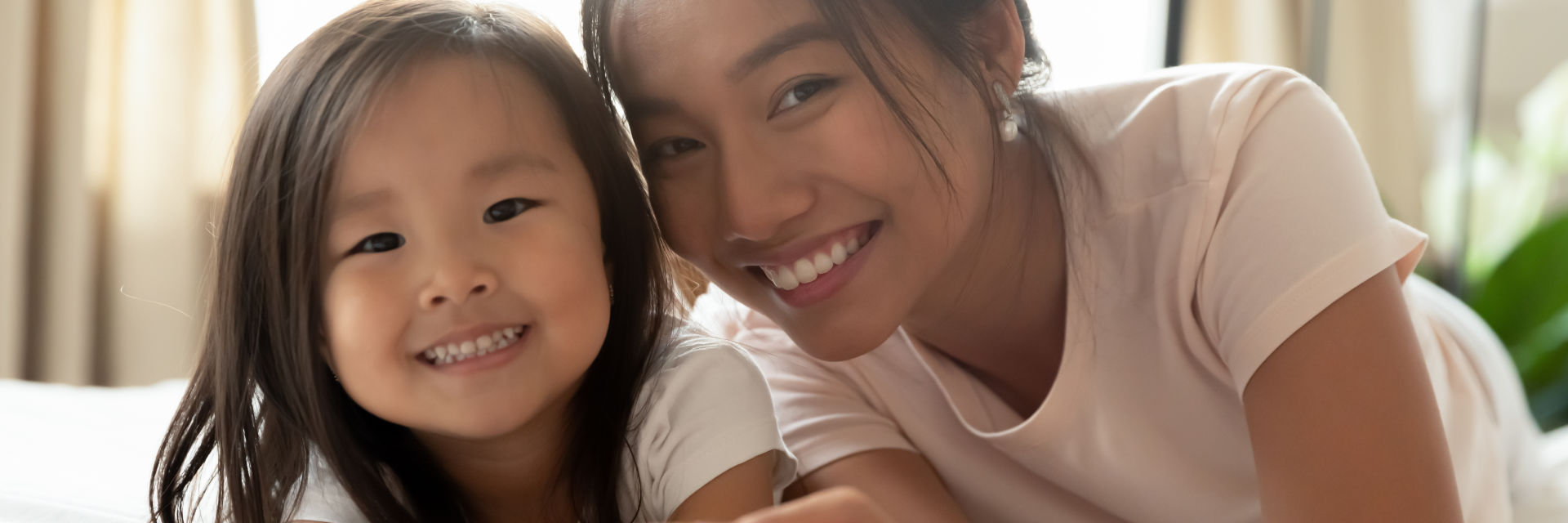 A happy Asian woman with her little daughter.