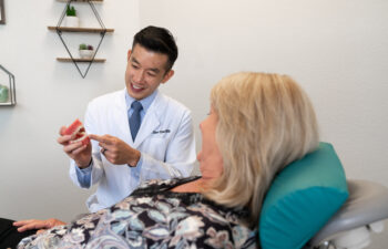 Highlands Ranch dentist teaching senior patient about dental inlays and onlays